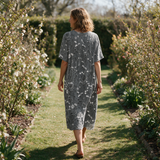 Delta spring dress back view on a garden path