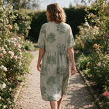 Luise spring dress back view on a garden path