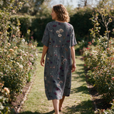 Marnie spring dress back view on a garden path