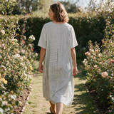Robyn spring dress back view on a garden path