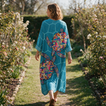 Milly spring dress back view on a garden path
