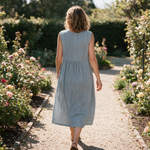 Marlene spring dress back view on a garden path