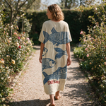 Sandra spring dress back view on a garden path