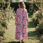Clothilde spring dress back view on a garden path