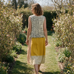 Simone spring dress back view on a garden path