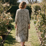 Lucy spring dress back view on a garden path