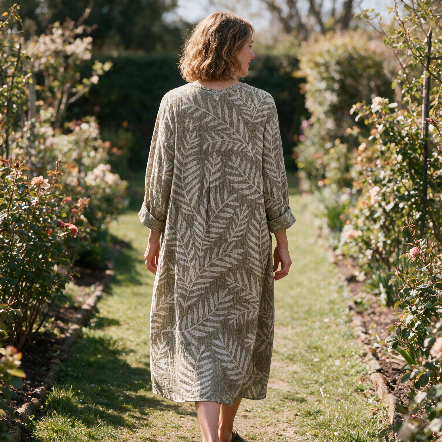 Lucy spring dress back view on a garden path