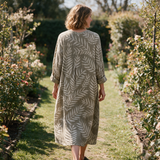 Lucy spring dress back view on a garden path