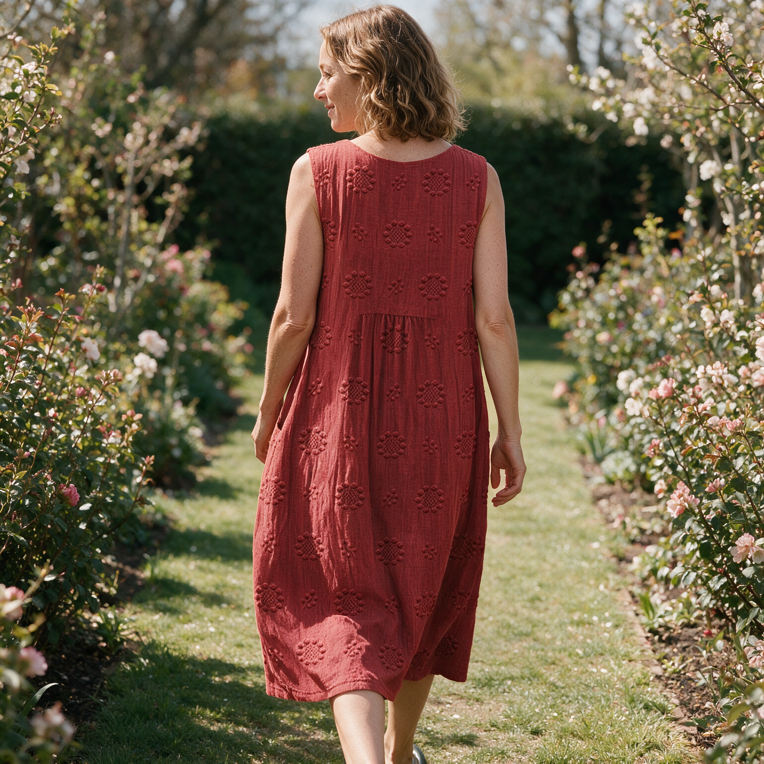 Tamsin spring dress back view on a garden path