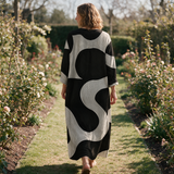 Melinda spring dress back view on a garden path