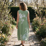 Liloue spring dress back view on a garden path