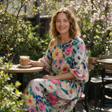 Fleur spring dress three quarter view at an outdoor cafe
