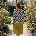 Matilda spring dress back view on a garden path