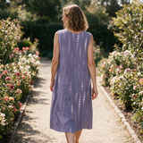 Roxanne spring dress back view on a garden path