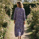 Michelle spring dress back view on a garden path