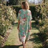 Evelyn spring dress back view on a garden path