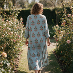 Wanda spring dress back view on a garden path