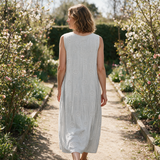 Faye spring dress back view on a garden path