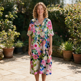 Caline spring dress front view on garden terrace