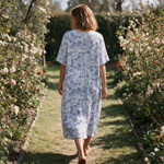 Nadine spring dress back view on a garden path
