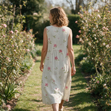 Zoe spring dress back view on a garden path