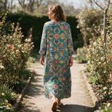 Nicole spring dress back view on a garden path