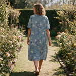 Frances spring dress back view on a garden path