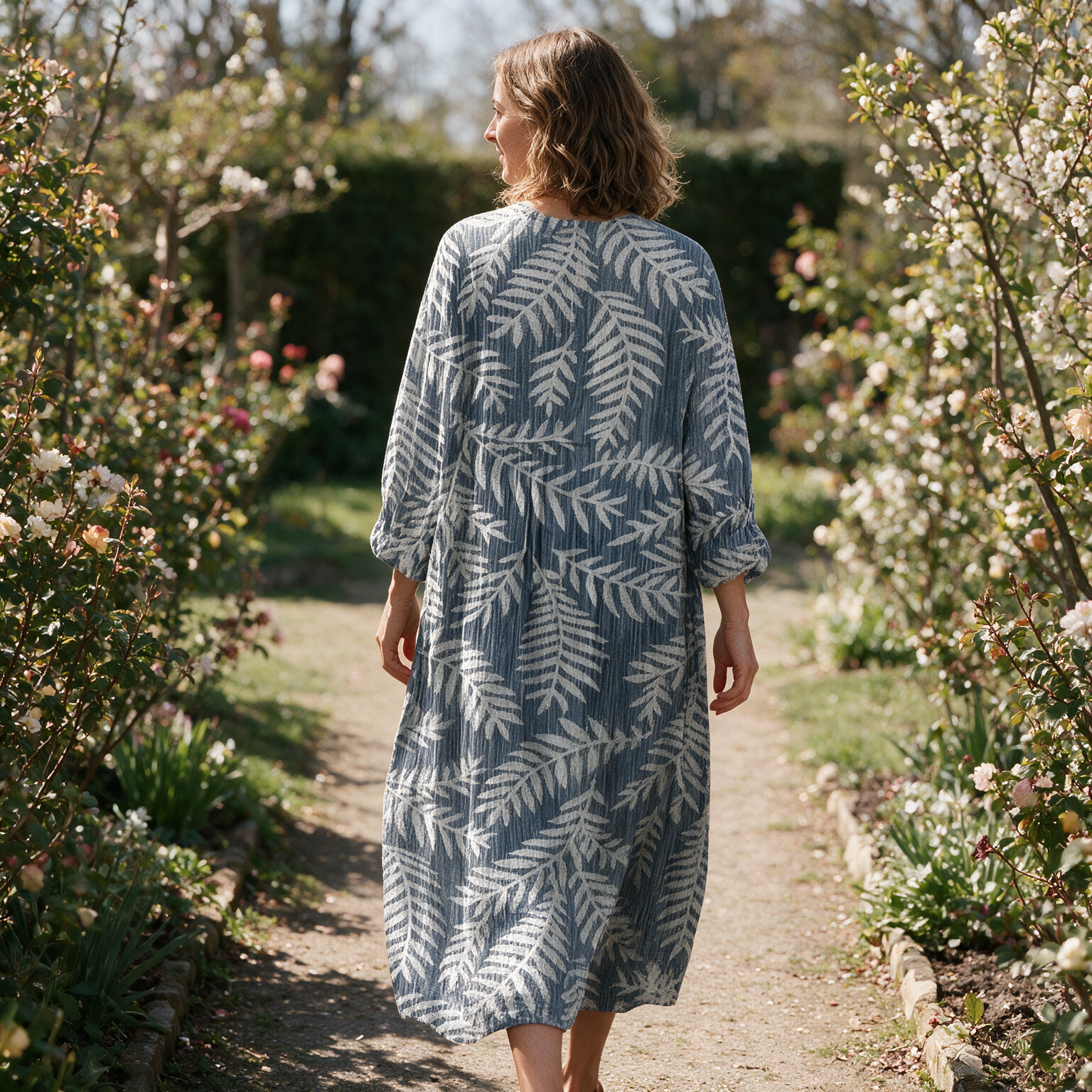 Lilouette spring dress back view on a garden path